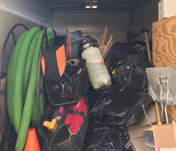 Van with bagged debris and equipment