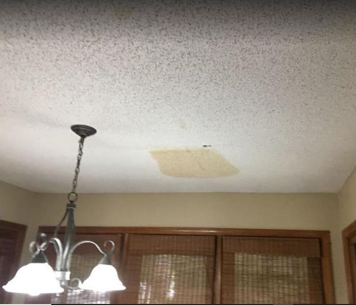 brown spot on ceiling showing water damage