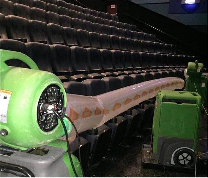 Drying equipment set to remove moisture in movie theater due to water damage