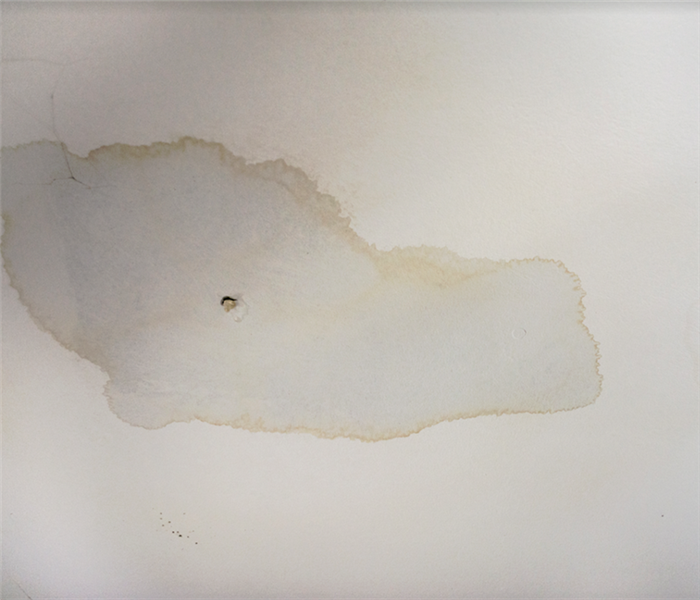 a water damaged ceiling with holes in it